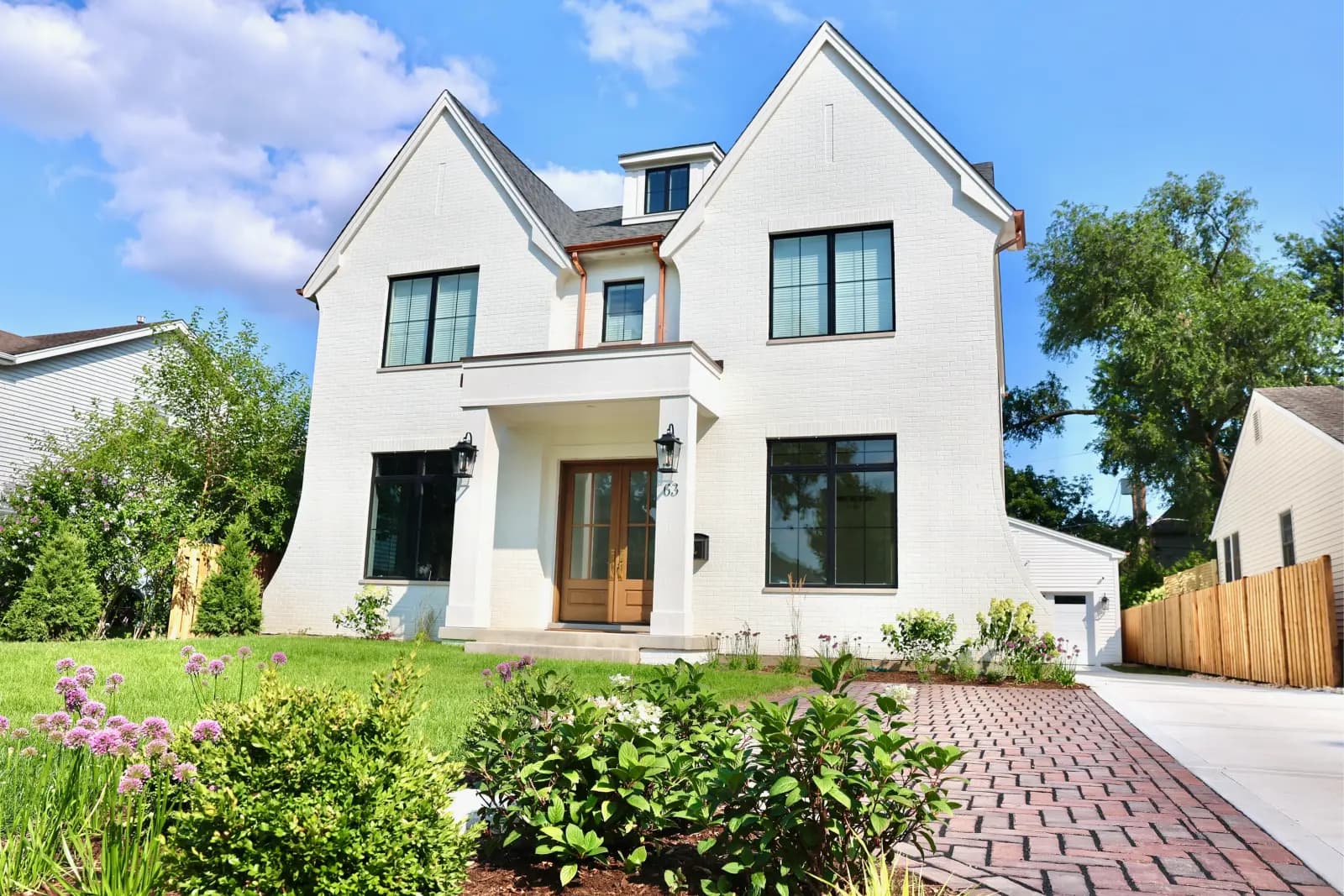 63 Waverly white-brick home with landscaped front garden